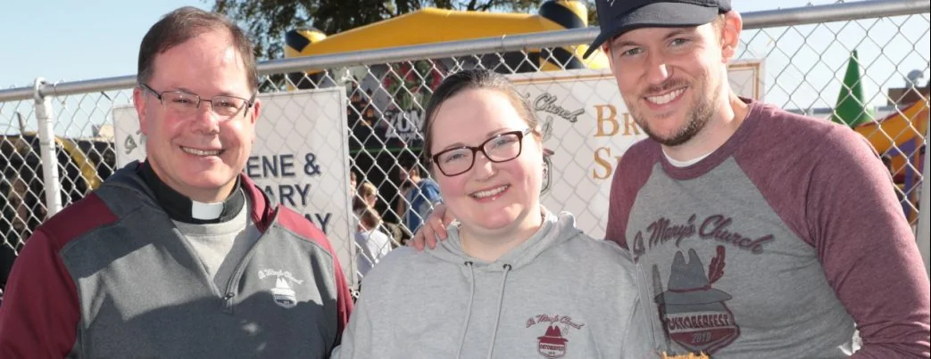 Family smiling near the Oktoberfest beer trailer