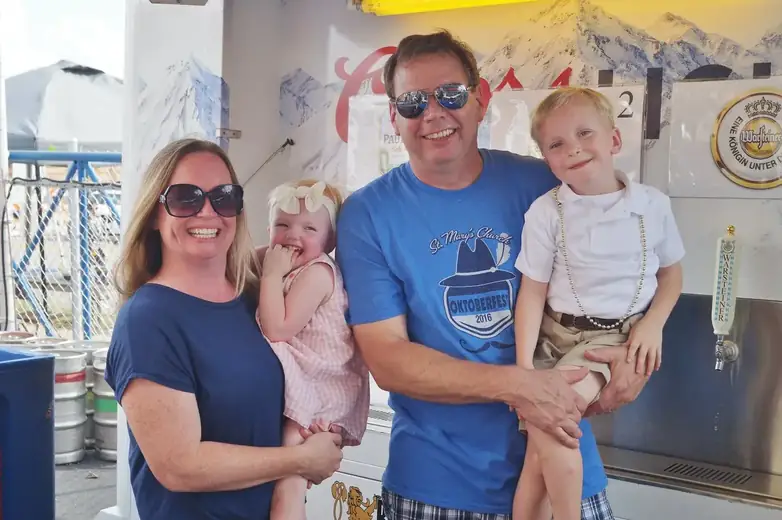 Family wearing St. Mary’s Oktoberfest sweatshirts at the event