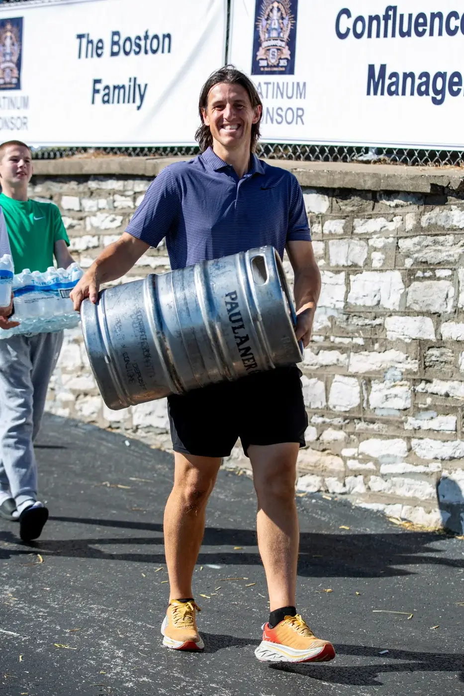 Volunteer carrying a beer keg on the Oktoberfest grounds