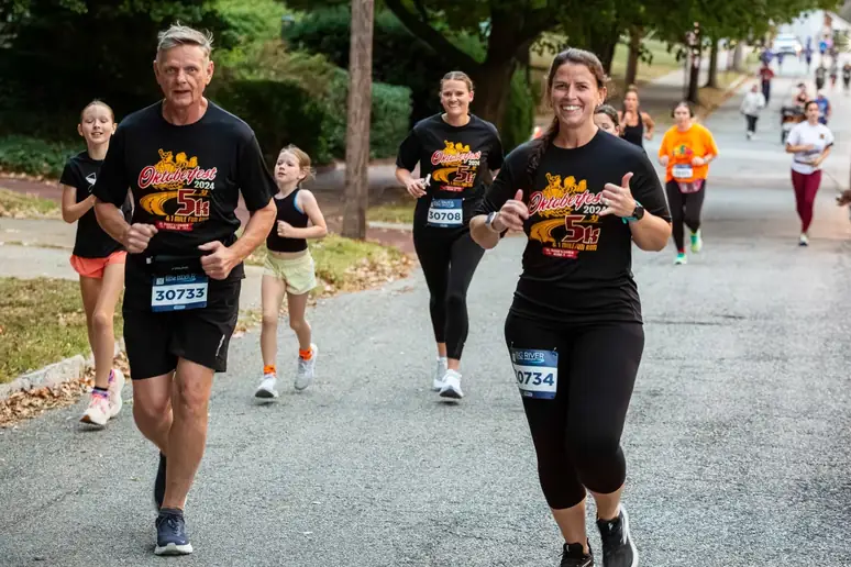 Runners from the Oktoberfest 5K smiling on the course